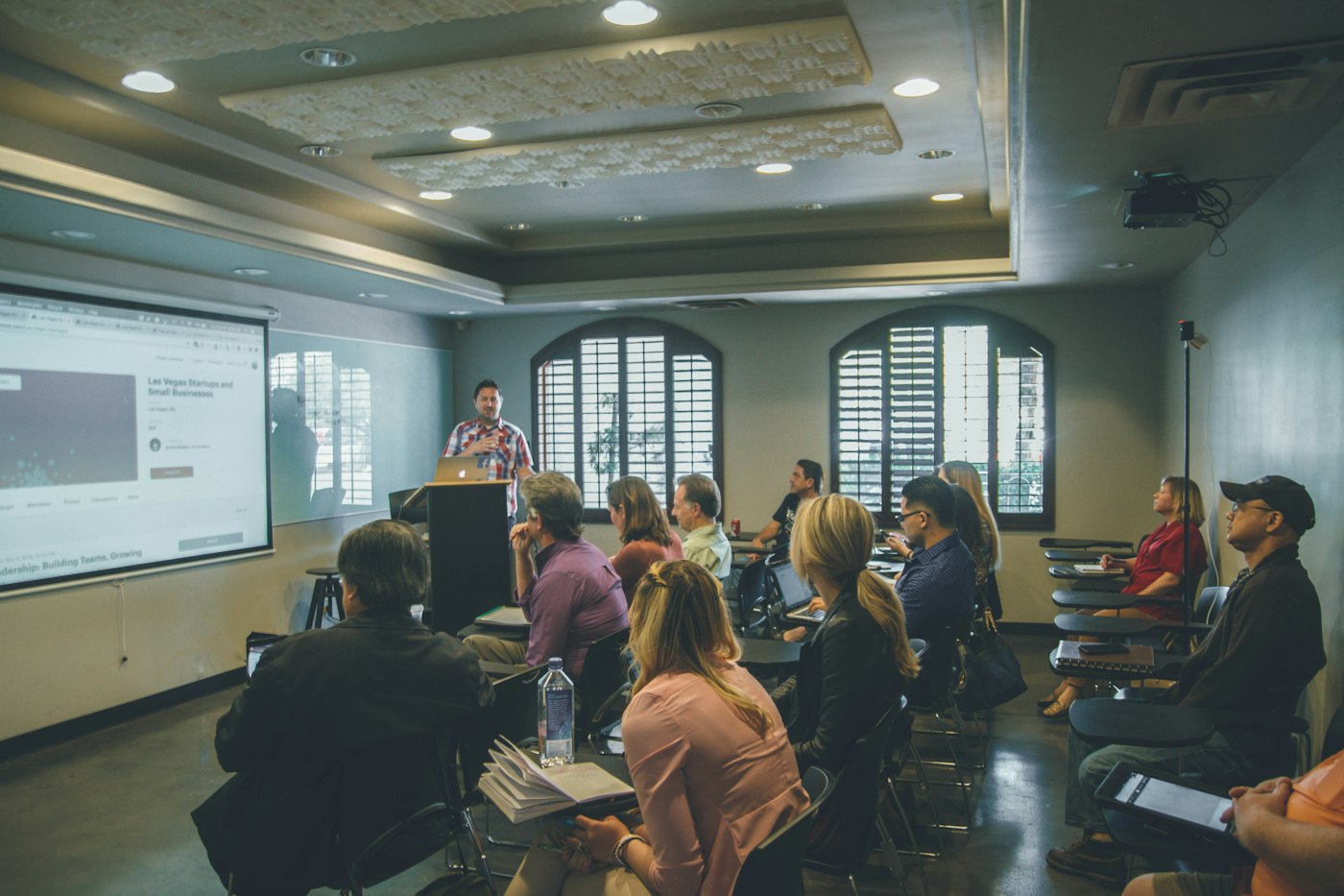 Learners and an instructor in a classroom, evoking investor education (illustrative image)